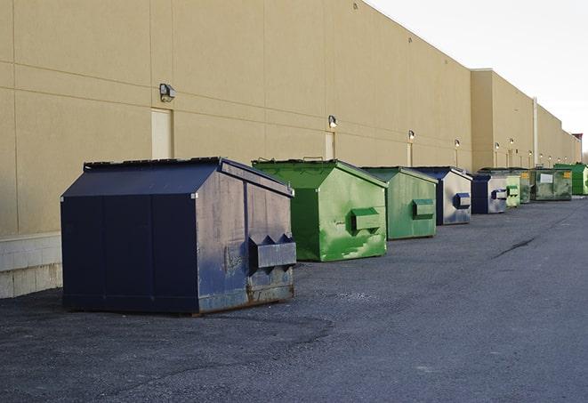 construction dumpsters on a worksite surrounded by caution tape in Cambridge